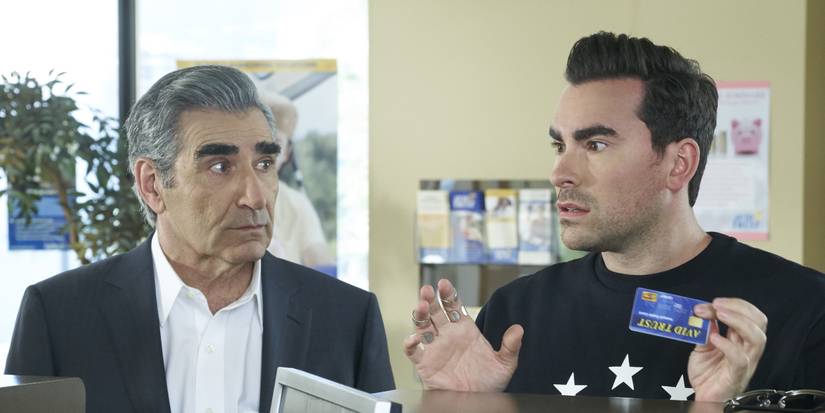 Dan and Eugene Levy look surprised at a service counter in Schitt's Creek.