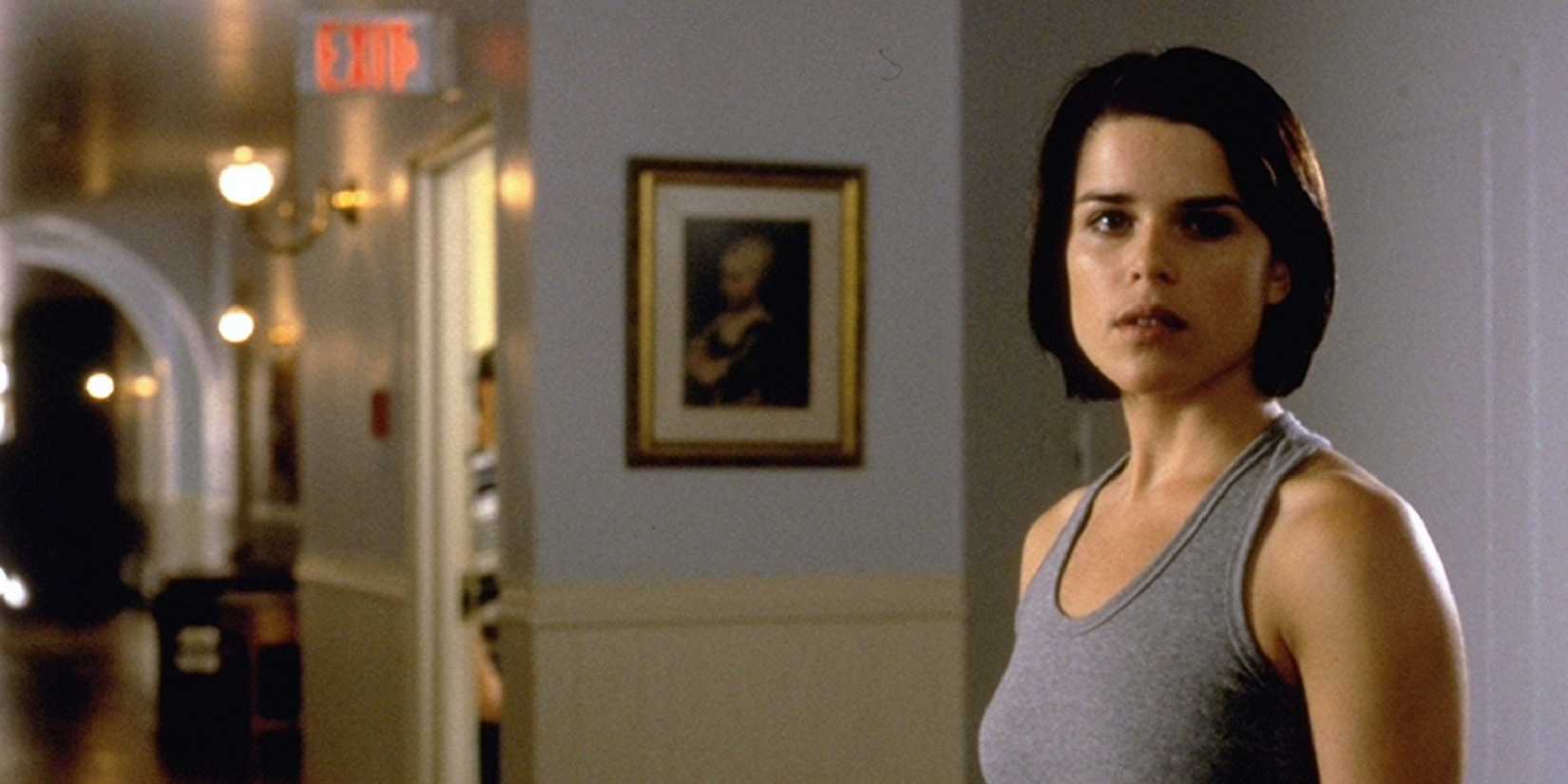 Sidney Prescott standing alone in a foyer in Scream 2