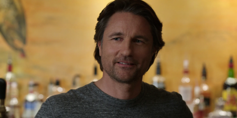 Jack Sheridan smiling at his bar in Virgin River.
