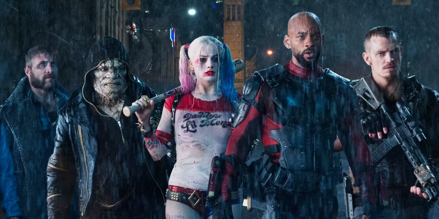 Jai Courtney as Captain Boomerang, Adewale Akinnuoye-Agbaje as Killer Croc, Margot Robbie as Harley Quinn, Will Smith as Deadshot, and Joel Kinnaman as Rick Flagg walking side by side in 2016's Suicide Squad