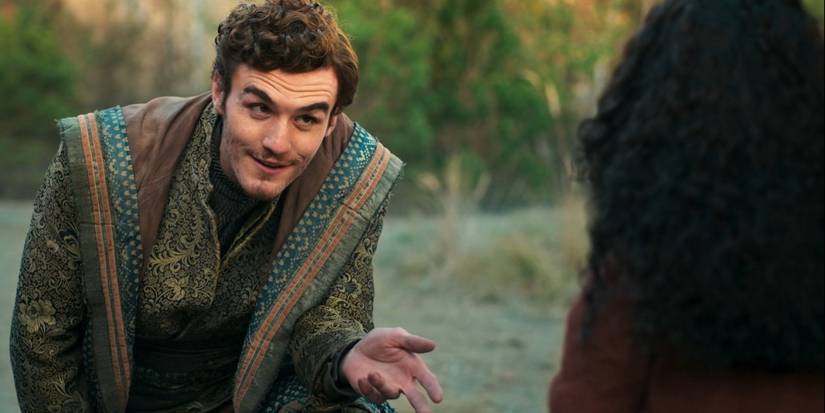 Dónal Finn as Mat Cauthon leaning forward and holding out his left hand in The Wheel of Time Season 2