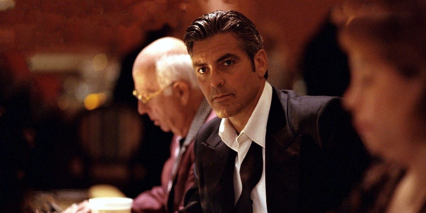 Danny Ocean (George Clooney) sitting at a betting table in Ocean's Eleven.
