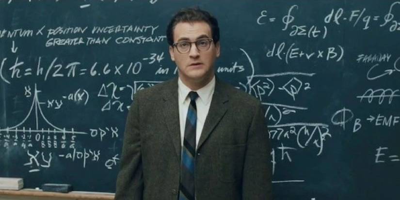 Michael Stuhlbarg as Larry Gopnik stands in front of a chalkboard looking slightly confused in 'A Serious Man'. 