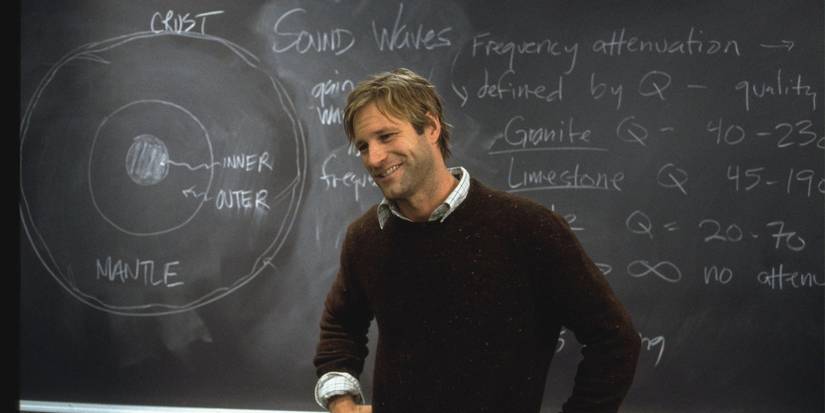 Aaron Eckhart as Josh Keyes, smiling in front of a chalkboard in The Core (2003)