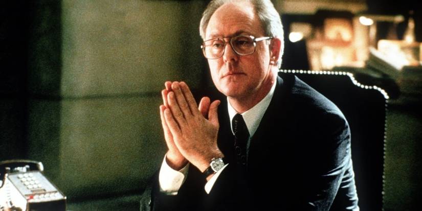 John Lithgow as Judge Walter Skinner with his hands together looking produ in the film A Civil Action