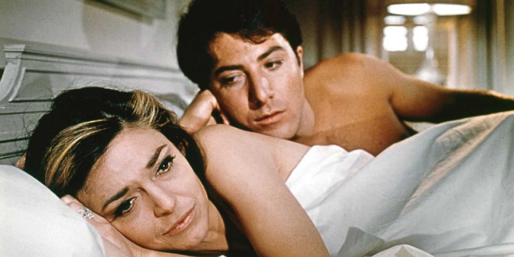 Anne Bancroft as Mrs. Robinson and Dustin Hoffman as Benjamin lie in bed together in The Graduate.