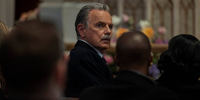 Roderick Usher (Bruce Greenwood) looking back in fear during a funeral service in The Fall of the House of Usher Episode 5