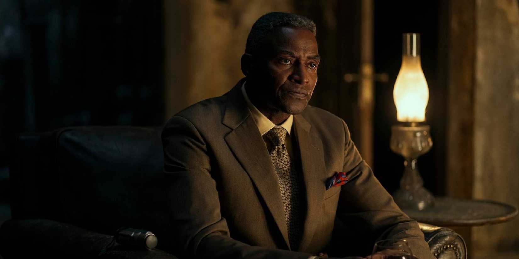 A medium close-up shot of Carl Lumbly as Auguste Dupin sitting down in Netflix's The Fall of the House of Usher.