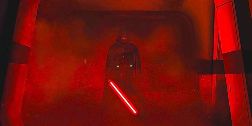 Darth Vader in a hallway of red light and smoke holding a red lightsaber in Rogue One: A Star Wars Story.