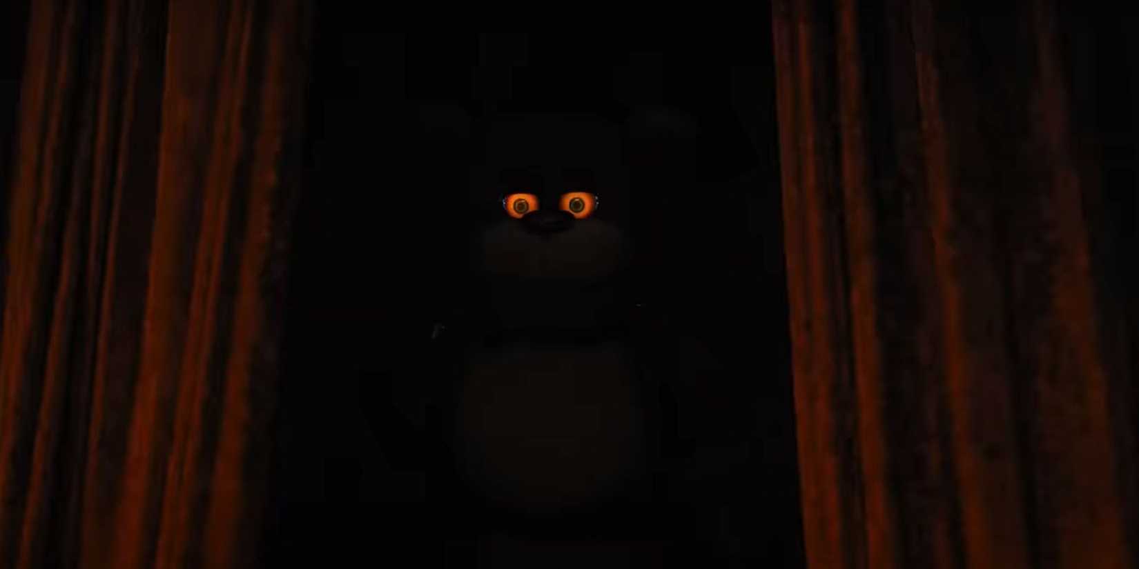 Freddy Fazbear lurks in the darkness of a stage