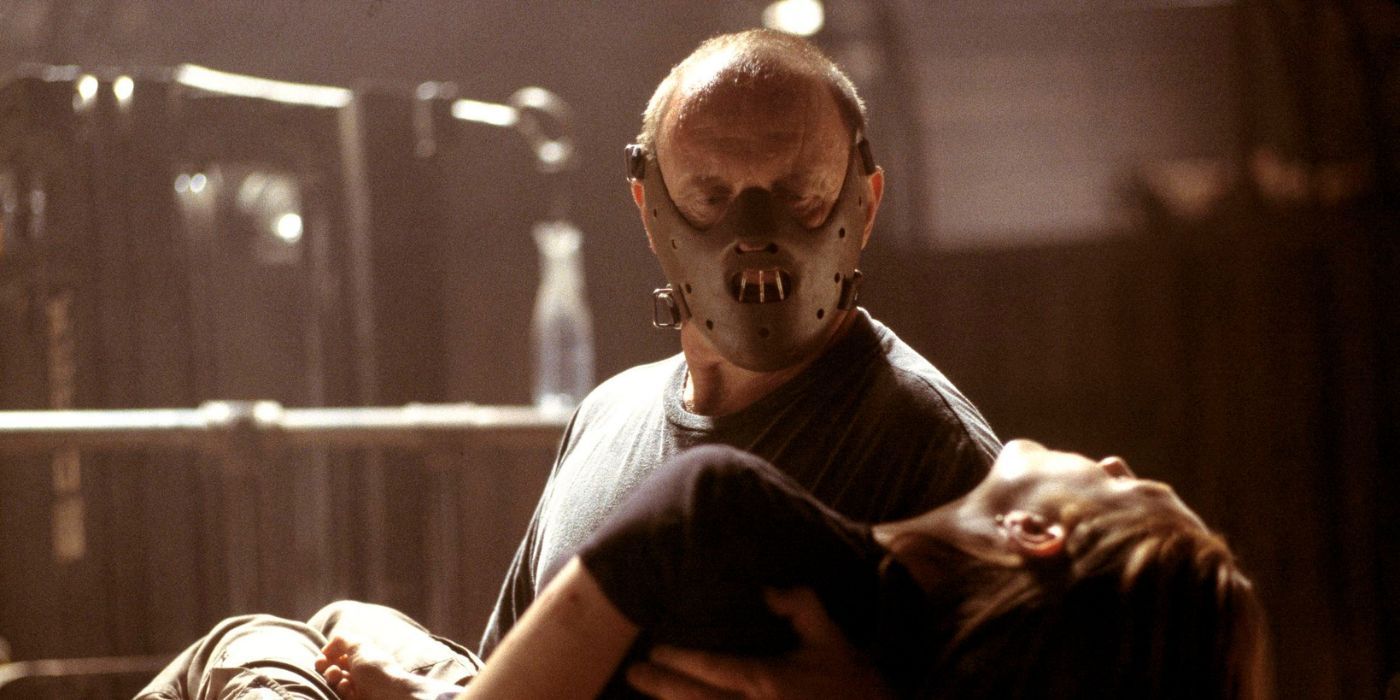 Anthony Hopkins as Hannibal wearing a mask carrying a passed out Clarice in Hannibal (2001)