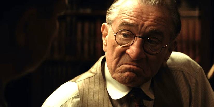 Robert De Niro as William "King" Hale wearing glasses and frowning in Killers of the Flower Moon. 