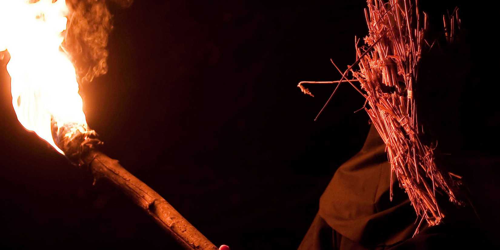 A man wearing a mask and holding a torch in Kill List