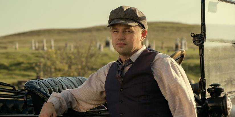 Leonardo DiCaprio as Ernest Burkhart leaning against his car in Killers of the Flower Moon