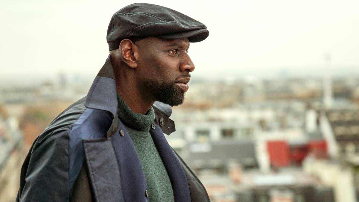 Omar Sy as Assane Diop, looking out over the city in Lupin