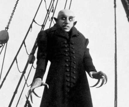 Max Schreck as Count Orlok standing on a ship in Nosferatu: A Symphony of Horror