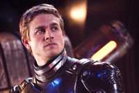 Charlie Hunnam in a metal suit with a serious expression looking to the side in Pacific Rim.