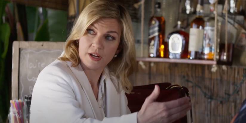 Rhea Seehorn looking to the side with whiskey bottles behind in Coopers Bar. 