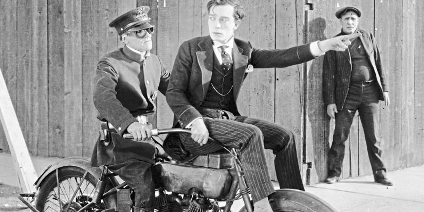Sherlock Jr. on a bike giving directions to a policeman in Sherlock Jr.