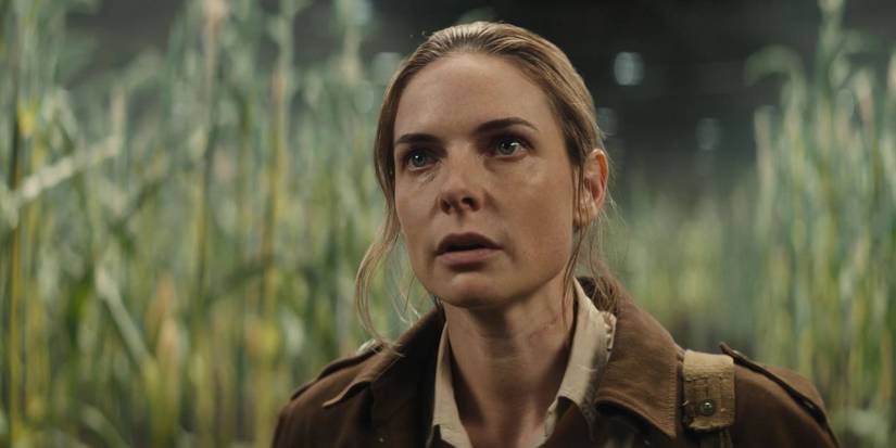 Rebecca Ferguson standing in a corn field in Silo