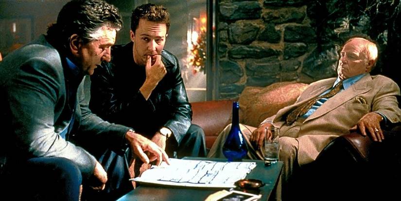 Robert De Niro, Edward Norton, and Marlon Brando sitting around a table in 'The Score'