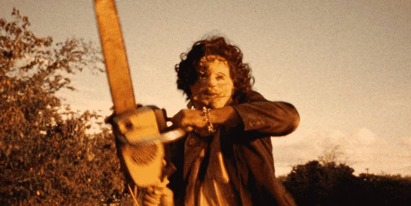 Gunnar Hansen as Leatherface wielding a chainsaw outside in Texas Chainsaw Massacre.