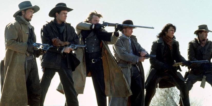 The cast of Young Guns pointing their guns at someone off camera