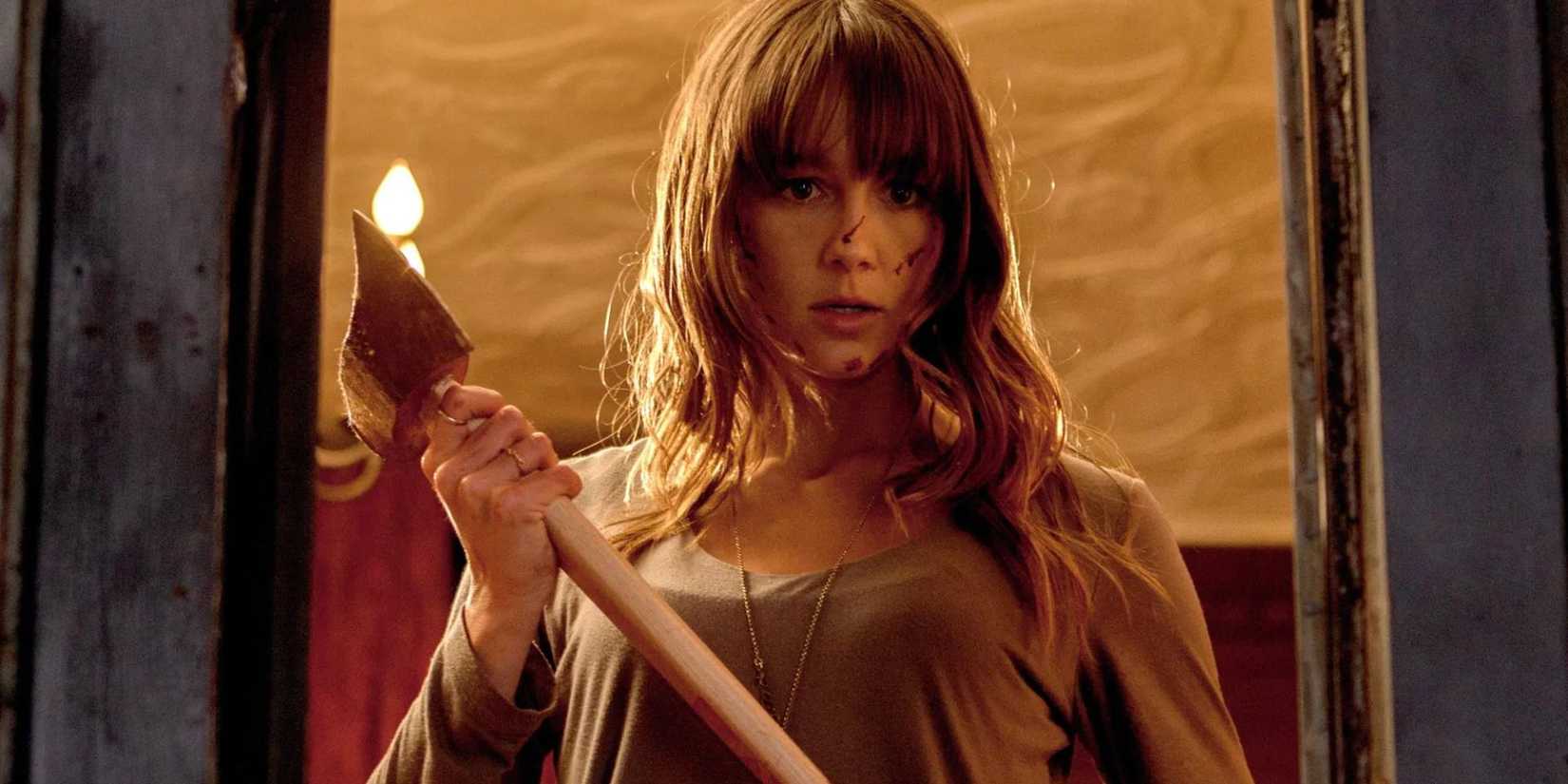 Erin wielding an axe looking down in You're Next.