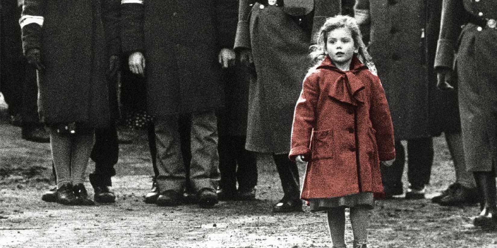 A little girl in a red coat walking alone in Schindler's List.