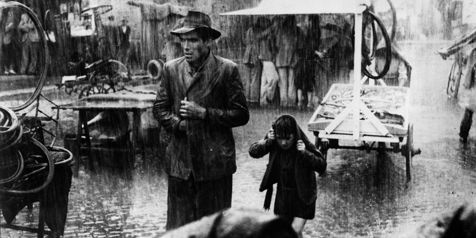 A father and son under the rain in Bicycle Thieves