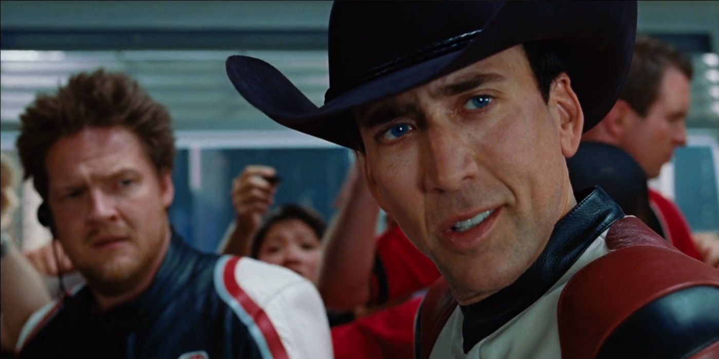 Johnny looking at someone to his left while Mack stands in the back in Ghost Rider