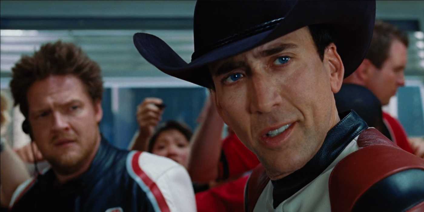 Johnny looking at someone to his left while Mack stands in the back in Ghost Rider