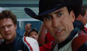 Johnny looking at someone to his left while Mack stands in the back in Ghost Rider
