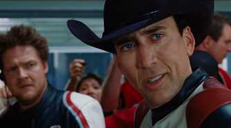 Johnny looking at someone to his left while Mack stands in the back in Ghost Rider
