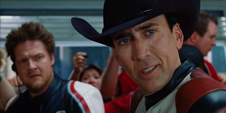 Johnny looking at someone to his left while Mack stands in the back in Ghost Rider