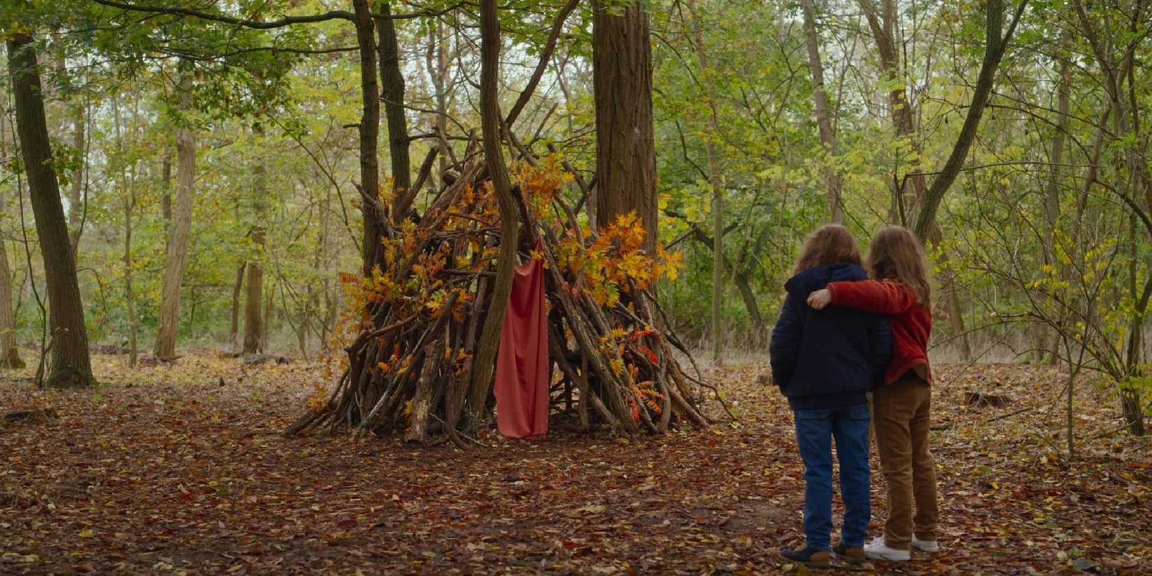Josephine and Gabrielle Sanz looking at a forest tent in Petite Maman.