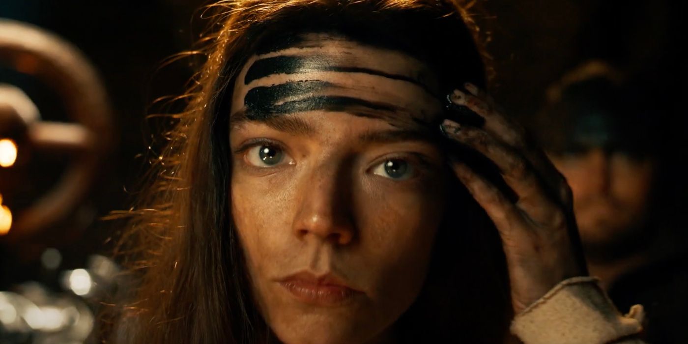 Anya Taylor-Joy streaks black war paint across her face in Furiosa: A Mad Max Saga