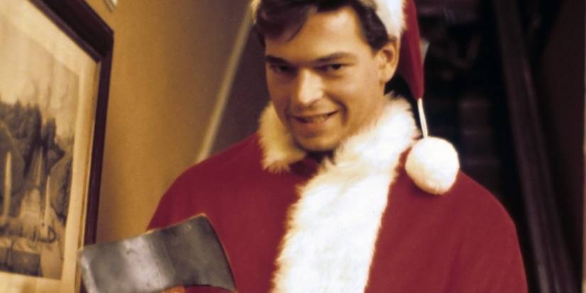 A man in a Santa Claus suit smiling while holding an axe in 'Silent Night, Deadly Night Part 2'