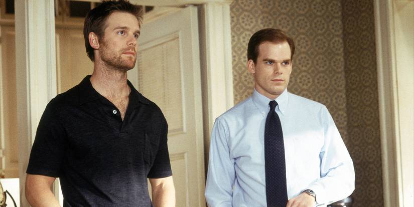 Peter Krause and Michael C. Hall in a house looking intently at something off-camera in Six Feet Under.