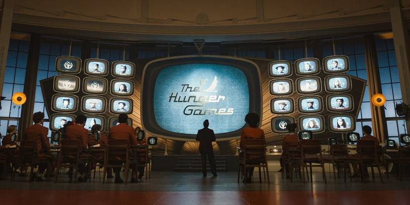Hunger Games TV Screens looms large in a room of academy students in Ballad of Songbirds & Snakes