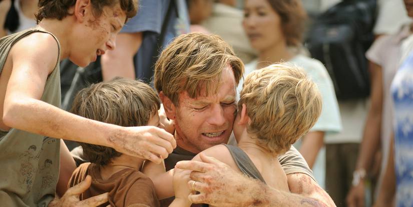 Ewan McGregor as Henry Bennett hugging his children and crying in The Impossible.