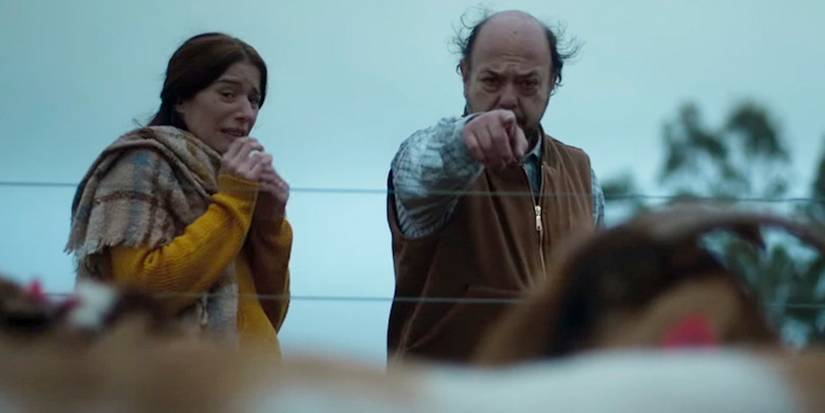 A woman crying while a man pointing at something beyond the camera in When Evil Lurks Film