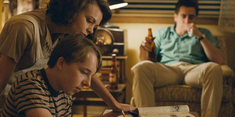 Carey Mulligan helps Ex Oxenbould with homework while Jake Gyllenhaal sits in the background with a beer in hand.