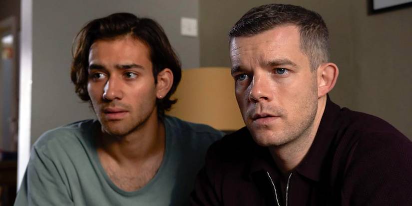 Russel Tovey and Maxim Baldry sit and look ahead with anxious expressions in Years and Years.