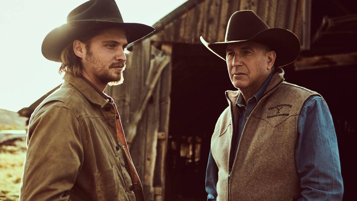 Luke Grimes as Kayce Dutton and Kevin Costner as John Dutton in the middle of a conversation on Yellowstone.