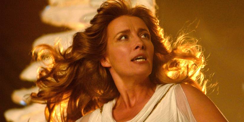 Emma Thompson in a white dress with gold light behind her in Angels in America.