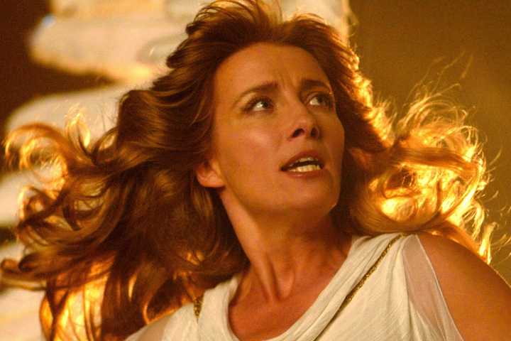 Emma Thompson in a white dress with gold light behind her in Angels in America.