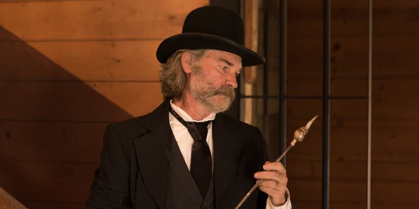 Kurt Russell as Sheriff Franklin Hunt holding a fire poker in Bone Tomahawk.