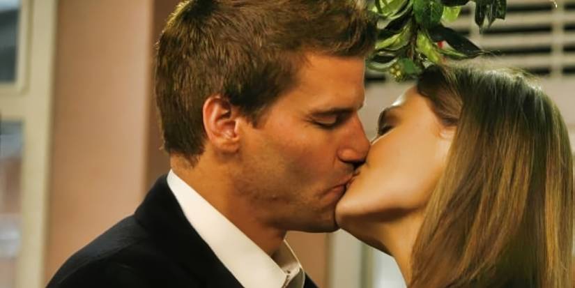 Booth (David Boreanaz) and Brennan (Emily Deschanel) kiss in 'Bones' "The Santa in the Slush" episode