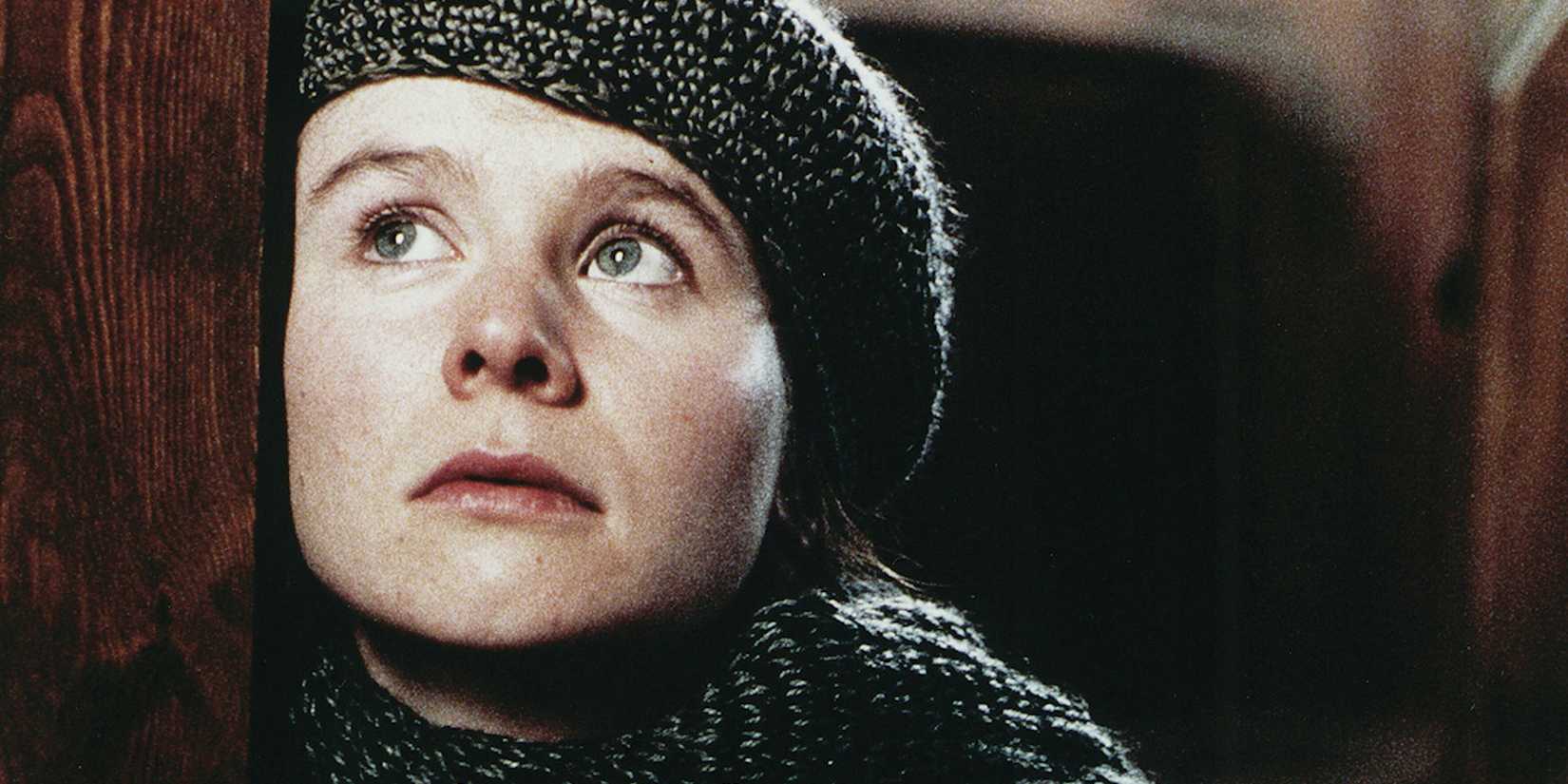 Emily Watson leaning her face against a door in Breaking the Waves.